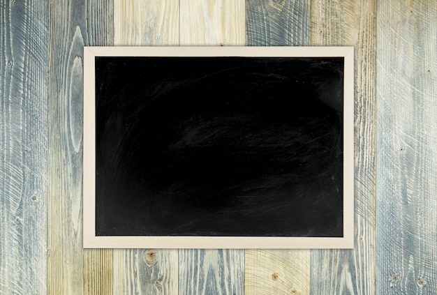 Photo blackboard with wooden frame, blackboard on old wood background for education concept.