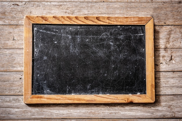 Blackboard on wooden surface