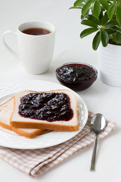 Blackcurrant jam on fresh bread and a Cup of tea.