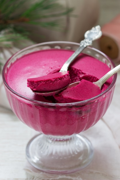 Blackcurrant, orange and cream mousse in a glass bowl. Rustic style, selective focus.