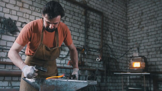 The blacksmith pulls out fire metal detail, wide angle