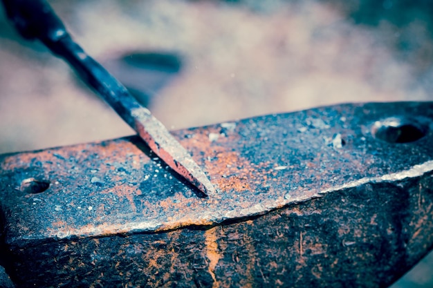 Blacksmith's hammer on an anvil manual labor