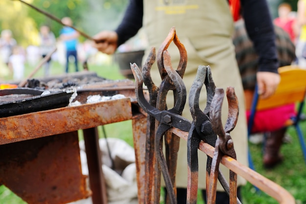 Blacksmith's tools against the backdrop of fire