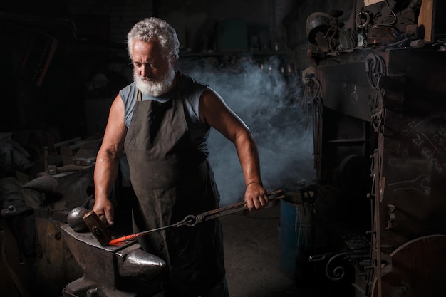 Blacksmith with brush handles molten metal