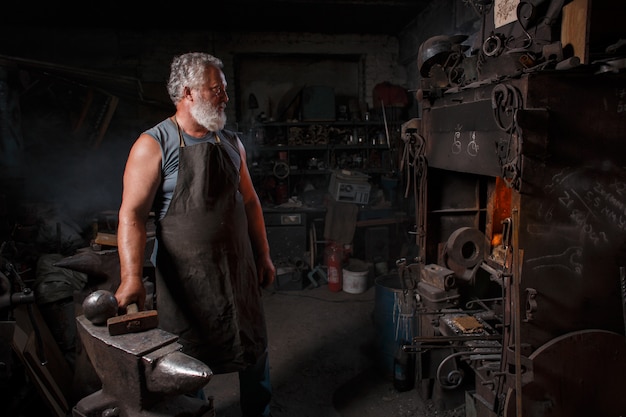 Blacksmith with brush handles molten metal