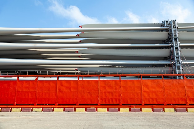 The blades from windmills are stacked in special mounts and chained on the deck of the ship