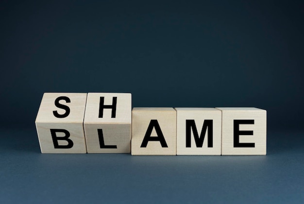 Blame or shame The cubes form the words shame or blame Concept of social problems in society  Blame or shame