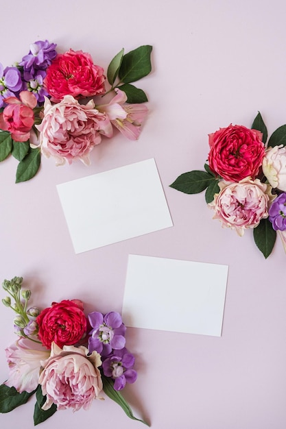 Blanco vel papier kaarten met mockup kopie ruimte roze en rood roze bloemknoppen op roze achtergrond Minimale esthetische zakelijke merk blog sociale media sjabloon achtergrond Plat lag bovenaanzicht