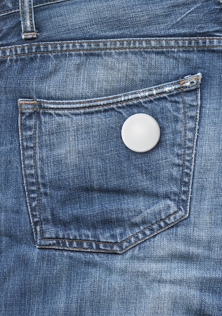 Blank badge on a blue denim pocket background