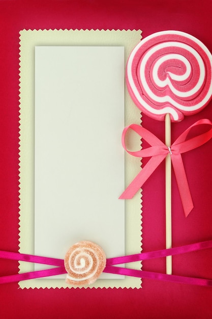 Blank banner with lollipop on pink background
