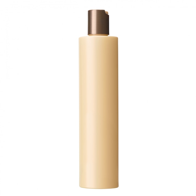 Blank beige plastic cosmetics or shampoo bottle isolated on white wall, no label