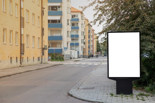 Blank billboard mock up on city road for text message or\
content.