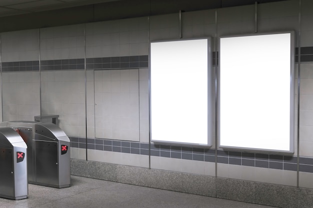 Photo blank billboard in subway or metro station, useful for advertising.