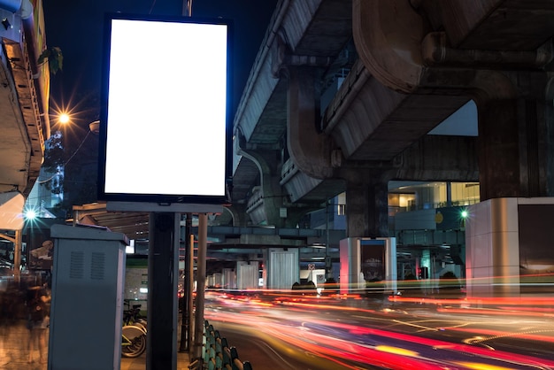 Photo blank billboard with copy space area for your text message or promotional content public information board next to road in night