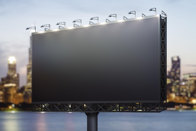 Photo blank black billboard on city buildings background at night perspective view mockup advertising concept