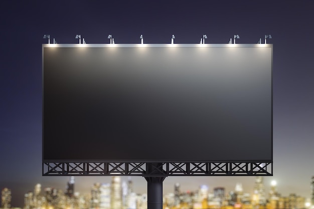 Blank black billboard on cityscape background at evening front
view mock up advertising concept