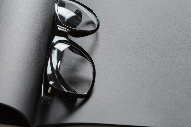 Blank black diary with eyeglasses