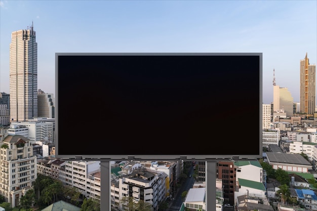 Blank black road billboard with Bangkok cityscape background at day time Street advertising poster mock up 3D rendering Front view The concept of marketing communication to promote or sell idea