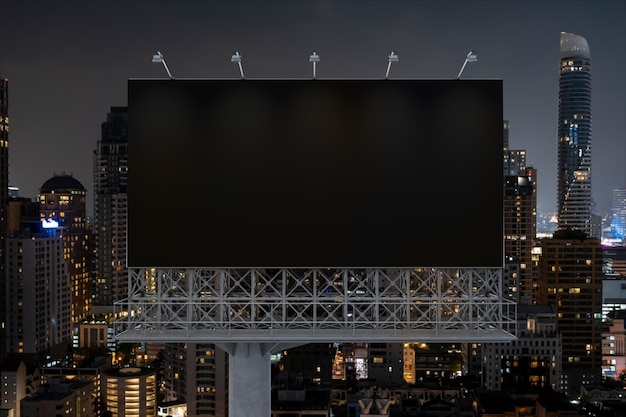 Blank black road billboard with Bangkok cityscape background at night time Street advertising poster mock up 3D rendering Front view The concept of marketing communication to sell idea