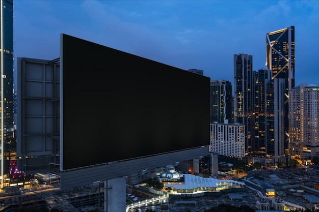 blank black road billboard with kl cityscape background at night time street advertising poster mock up 3d rendering side view the concept of marketing communication to promote or sell idea