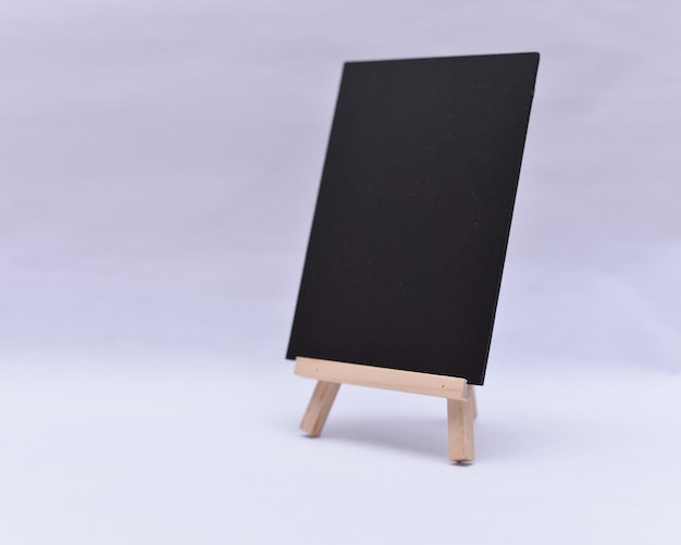 Blank blackboard against wall