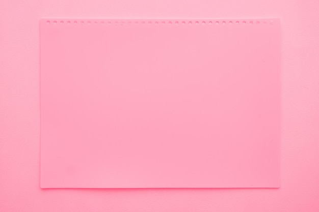 Photo blank blank title page from pink notepad on pink background space for copy model for designer blank paper sheet surface