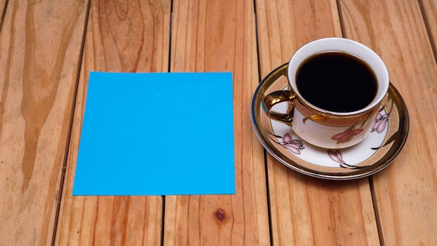 Blank blue paper for quotes with coffee on top wood table