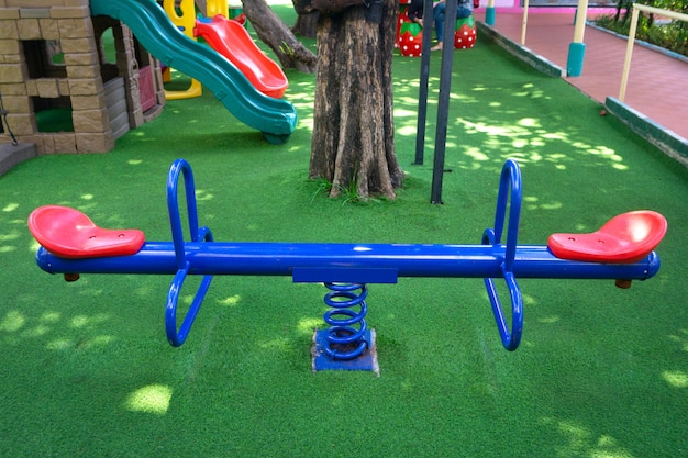 Photo blank blue teeterboard on the kids playground in garden