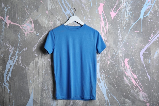 Blank blue tshirt on grunge background