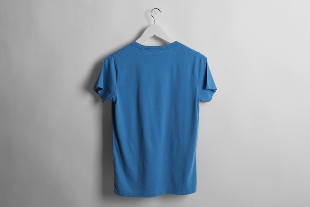 Blank blue tshirt on light background