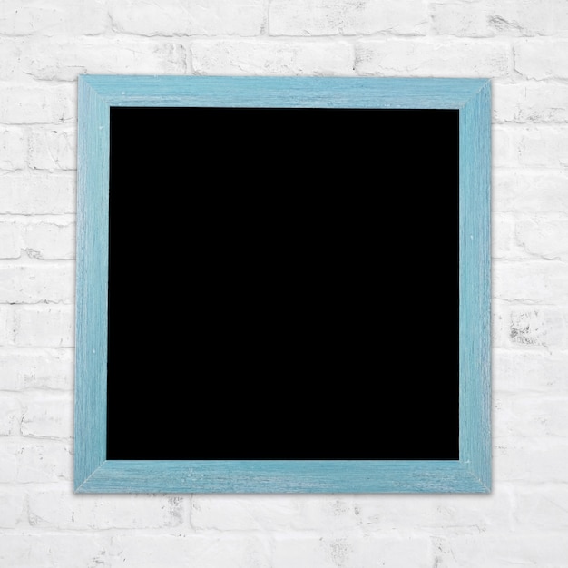 Blank blue vintage wood chalkboard on white brick wall background