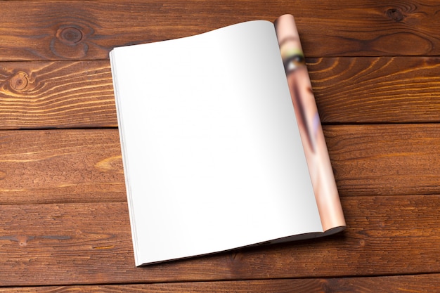 Blank book or magazine cover on wood background