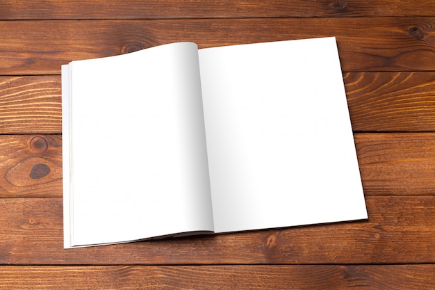 Blank book or magazine cover on wood table