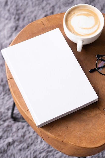 blank book mockup on coffee table with decorations and grey rug