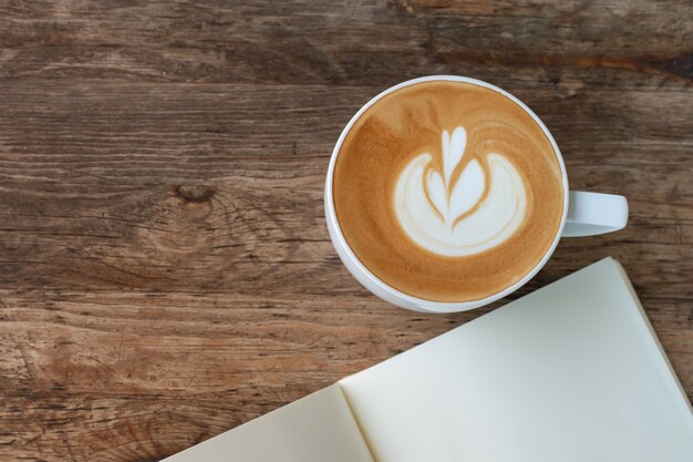 Blank booklet on wooden table with A cup of coffee