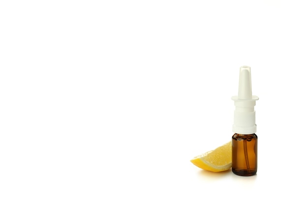 Blank bottle of nasal spray and lemon slice isolated on white background