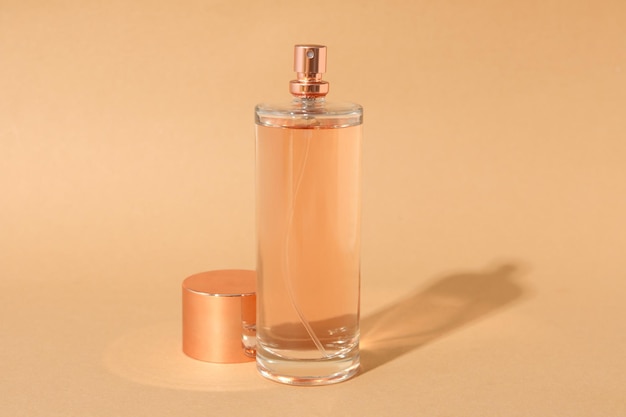 Blank bottle of perfume on beige background