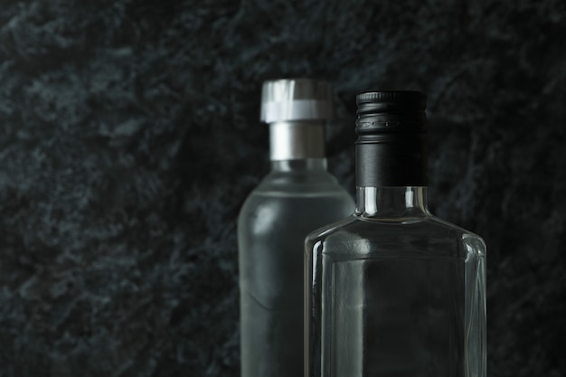 Blank bottles of vodka on black smokey