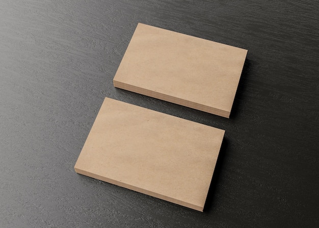 Photo blank brown cardboard business cards on dark wooden table. mockup for branding identity. two stacks, to show both sides of card. template for graphic designers. feee space, copy space.