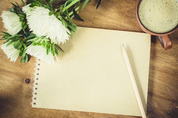 Blank brown notebook with autumn flowers.