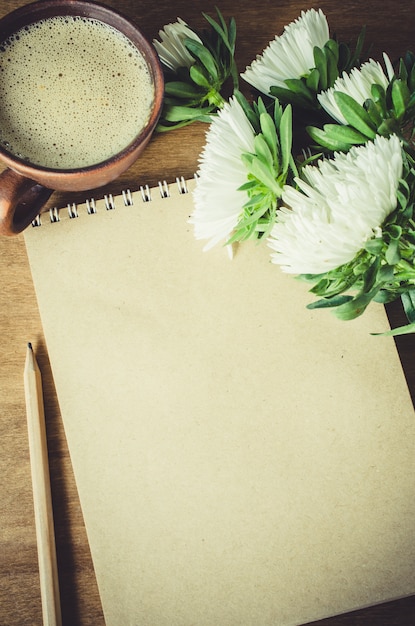 Blank brown notebook with autumn flowers.