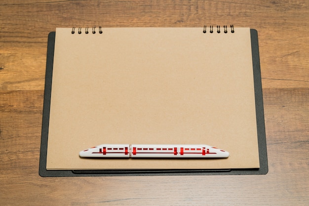 Photo blank brown paper sheet with train shape pen