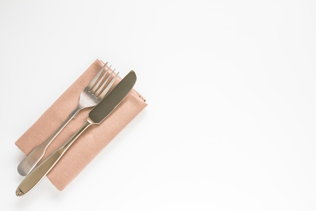 Blank brown restaurant napkin mockup with knife and fork