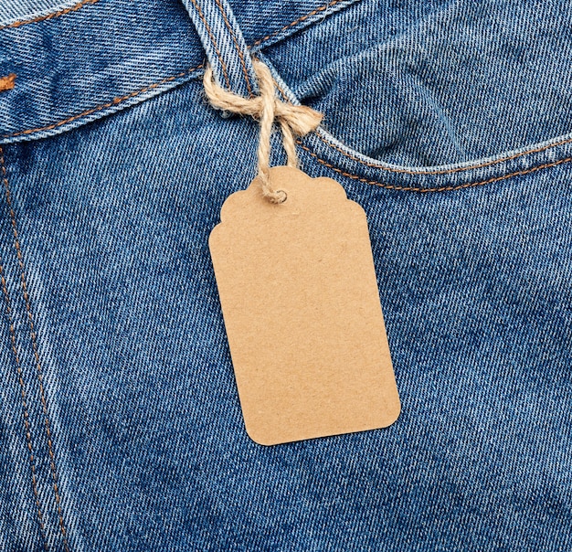Photo blank brown tag tied to a pocket