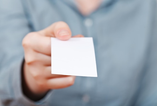 Blank business card in female fingers