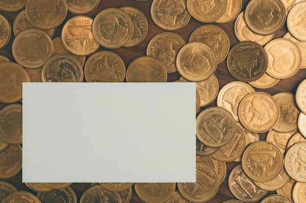 Blank business card or name card and stack of coin