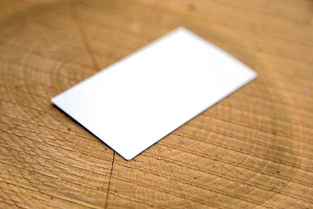 Blank business card on a wooden surfaces