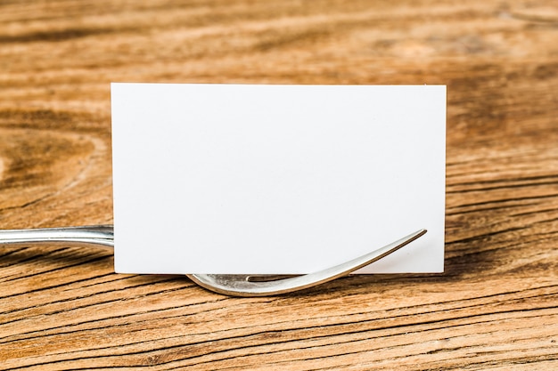 Blank business cards and cup of coffee on wooden table. Corporate stationary branding mock up.