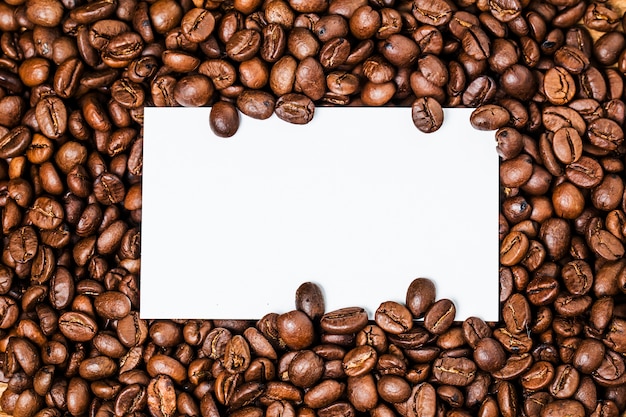 Photo blank business cards and cup of coffee on wooden table. corporate stationary branding mock up.