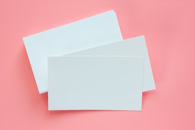 Blank business cards on pink background